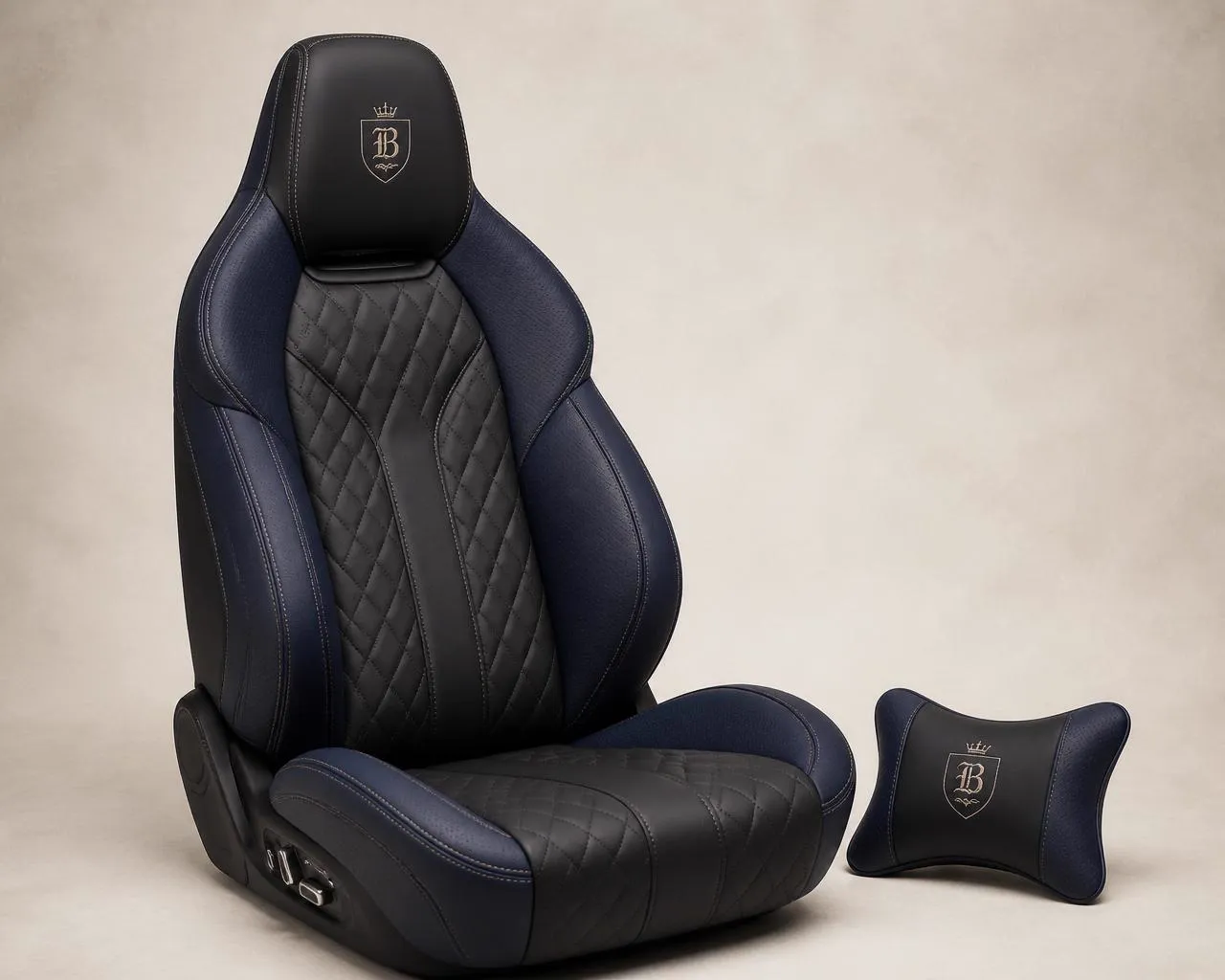 Bespoke automotive seat in navy blue and black leather with diamond quilted center panel, perforated bolsters and matching neck pillow